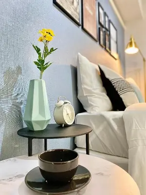 a table with a vase and a clock on it at Alo BnB 6 - Near IKEBUKURO, SHINJUKU, UENO, AKIHABARA - Self check-in in Tokyo