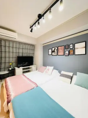 a bedroom with two beds and a television in it at Alo BnB 6 - Near IKEBUKURO, SHINJUKU, UENO, AKIHABARA - Self check-in in Tokyo