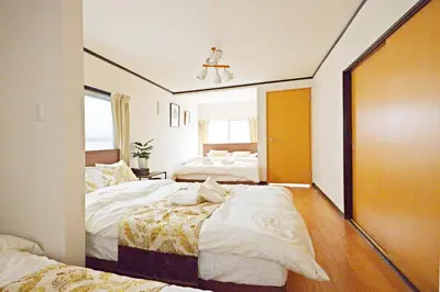 a hotel room with two beds and a mirror at YUZU HOUSE in Tokyo