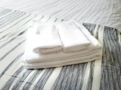 three towels stacked on top of a bed at Tsunoya in Tokyo