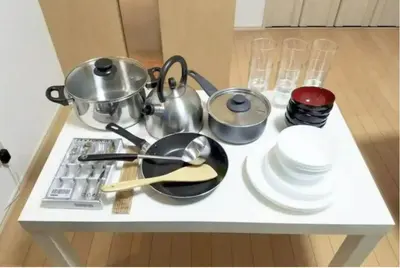 a kitchen counter with pots and pans and dishes on it at Tsunoya in Tokyo