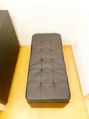 a brown couch sitting on top of a floor at Tsunoya in Tokyo