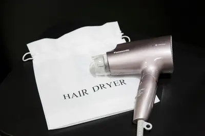 a hair dryer sitting next to a piece of paper at HOTEL TAVINOS ASAKUSA - Vacation STAY 64893 in Tokyo