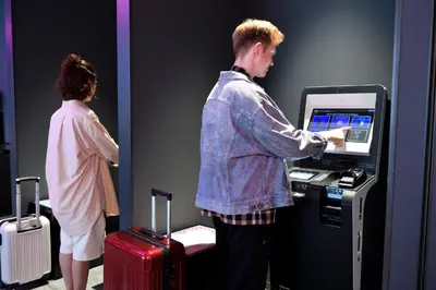 a man and a woman standing in front of a cash register at HOTEL TAVINOS ASAKUSA - Vacation STAY 64893 in Tokyo