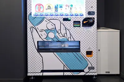 a vending machine with a picture of a woman at HOTEL TAVINOS ASAKUSA - Vacation STAY 64889 in Tokyo