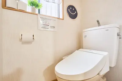 a bathroom with a white toilet and a window at Comfy Home Koiwa in Tokyo