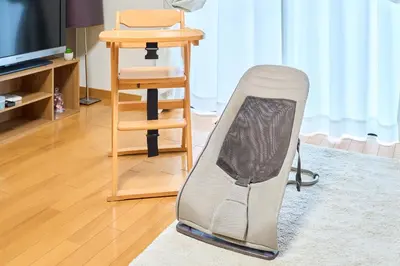 a chair sitting in a living room next to a table at Comfy Home Koiwa in Tokyo