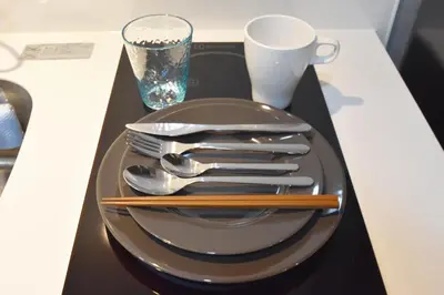 a plate with utensils on a black tray at Tune Inn Ebisu #1 in Tokyo