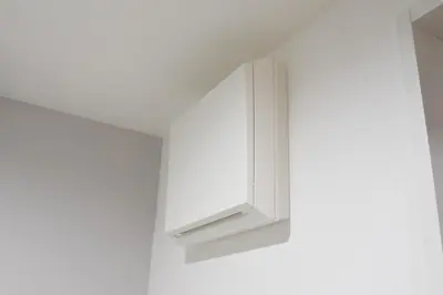 a white cabinet hanging on a white wall at Tune Inn Ebisu #1 in Tokyo