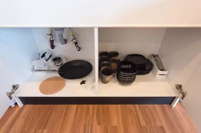 a kitchen shelf with pots and pans on it at TORA HOTEL Tokyo Skytree \u5bc5\u30db\u30c6\u30eb \u30b9\u30ab\u30a4\u30c4\u30ea\u30fcF in Tokyo