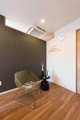 a chair in a room with a black wall at TORA HOTEL Tokyo Skytree \u5bc5\u30db\u30c6\u30eb \u30b9\u30ab\u30a4\u30c4\u30ea\u30fcD in Tokyo