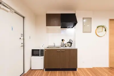 a small kitchen with a sink and a microwave at TORA HOTEL Tokyo Skytree \u5bc5\u30db\u30c6\u30eb \u30b9\u30ab\u30a4\u30c4\u30ea\u30fcD in Tokyo