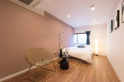 a bedroom with a bed and a chair and a window at TORA HOTEL Tokyo Skytree \u5bc5\u30db\u30c6\u30eb \u30b9\u30ab\u30a4\u30c4\u30ea\u30fcB in Tokyo