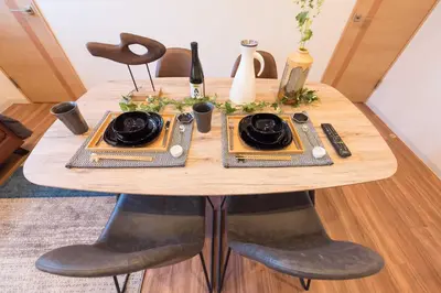 a wooden table with two plates on top of it at TORA HOTEL Tokyo Skytree \u5bc5\u30db\u30c6\u30eb \u30b9\u30ab\u30a4\u30c4\u30ea\u30fcB in Tokyo