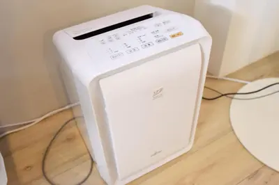 a white computer monitor sitting on a wooden floor at Tune Inn Ebisu in Tokyo