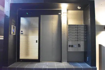 a bathroom with a door with a sign on it at Tune Inn Ebisu in Tokyo