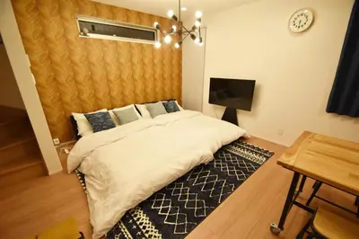 a bedroom with a large bed and a table at FINOA Residential Suite Asakusa/Oshiage Skytree in Tokyo