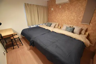 a bedroom with a large bed in a room at FINOA Residential Suite Asakusa/Oshiage Skytree in Tokyo