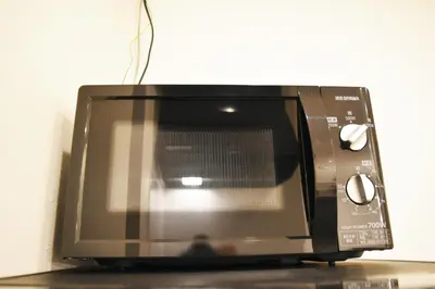 a microwave oven sitting on top of a counter at FINOA Residential Suite Asakusa/Oshiage Skytree in Tokyo