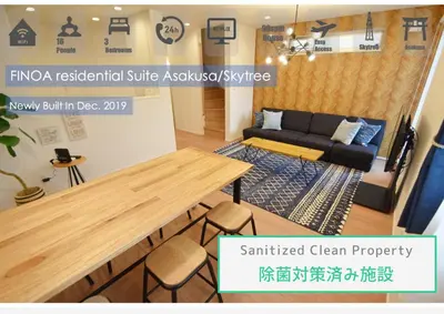a living room with a table and a couch at FINOA Residential Suite Asakusa/Oshiage Skytree in Tokyo