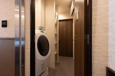 a room with a washing machine and a hallway at Stay SAKURA Tokyo Asakusa Edo no Mai in Tokyo