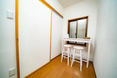 a small room with a mirror and two stools at ACOE OKUBO - 3 BR Home in Shinjuku's Food Heaven Area in Tokyo