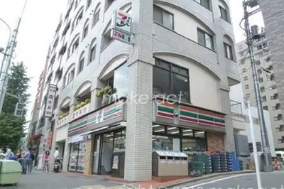 a building on a street with people walking in front of it at Tokyo Kakan in Tokyo