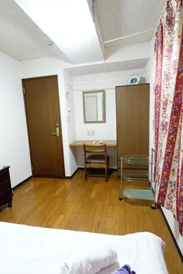 a bedroom with a bed and a desk and a table at Tokyo Kakan in Tokyo