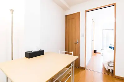 a white room with a table and a mirror at Yahiro 4-chome House 1F in Tokyo