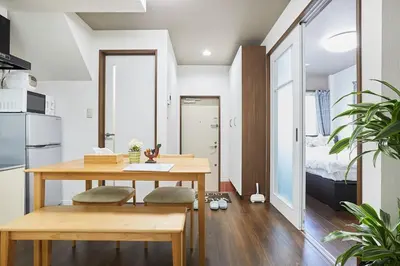 a kitchen and dining room with a table and a bed at Ka's house in Tokyo