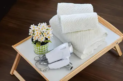 a tray with a hair dryer and flowers and towels at Ka's house in Tokyo