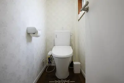 a bathroom with a white toilet in a room at Ka's house in Tokyo