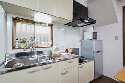 a small kitchen with a sink and a refrigerator at Ka's house in Tokyo