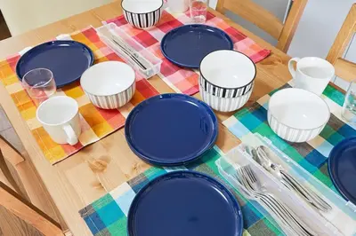 a table with blue plates on a colorful table cloth at Sun white Gyoutoku 303 in Tokyo