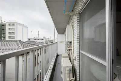 a balcony with a bench on the side of a building at Sun white Gyoutoku 202 in Urayasu