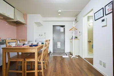 a kitchen and dining room with a wooden table and chairs at Sun white Gyoutoku 202 in Urayasu