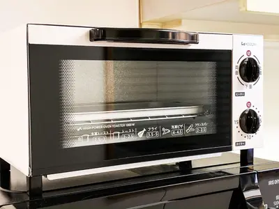 a microwave oven sitting on top of a counter at Yahiro 4-chome House 2F,3F in Tokyo