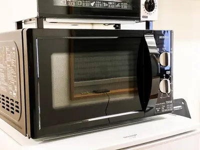 a microwave oven sitting on top of a counter at Yahiro 4-chome House 2F,3F in Tokyo
