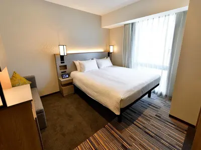 a hotel room with a bed and a window at Asakusa Tobu Hotel in Tokyo