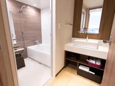a bathroom with a tub and a sink and a shower at Asakusa Tobu Hotel in Tokyo