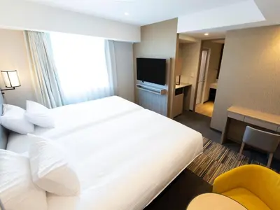 a hotel room with a large bed and a television at Asakusa Tobu Hotel in Tokyo