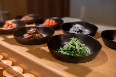 a group of bowls of food on a wooden table at Asakusa Tobu Hotel in Tokyo