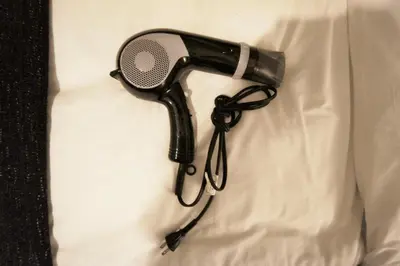 a hair dryer is hanging on a wall at H2O Stay Kikukawa Woody Sunheim #201 in Tokyo