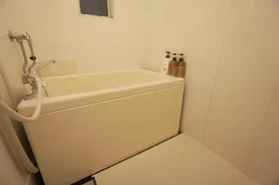 a white bath tub in a small bathroom at H2O Stay Kikukawa Woody Sunheim #201 in Tokyo