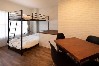 a room with a table and a bunk bed at Hotel Litlle Bird OKU-ASAKUSA in Tokyo