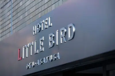 a sign for the hotel litzitzitz building at Hotel Litlle Bird OKU-ASAKUSA in Tokyo