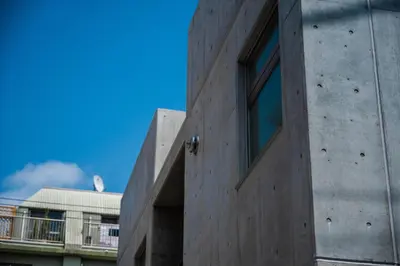 a concrete building with a window on the side of it at bmj Hyakunincho in Tokyo