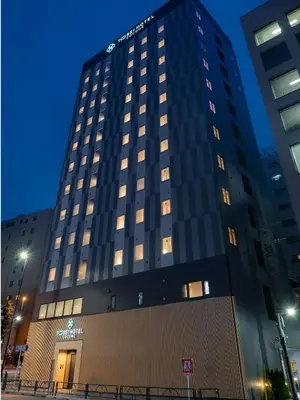 a tall black building with lights on at Tosei Hotel Cocone Asakusa Kuramae in Tokyo