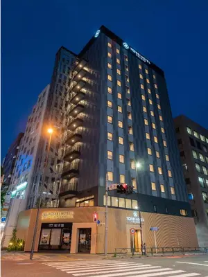 a tall building with a street light in front of it at Tosei Hotel Cocone Asakusa Kuramae in Tokyo