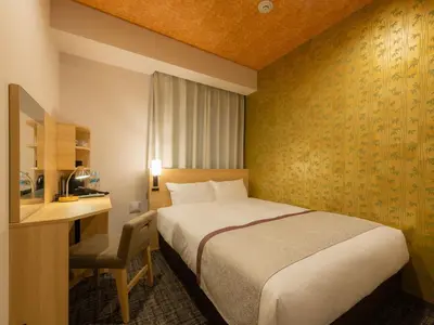 a hotel room with a bed and a desk at Tosei Hotel Cocone Asakusa Kuramae in Tokyo